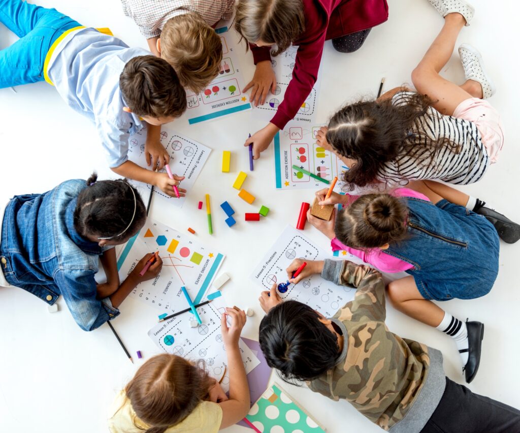 Group of kids writing and studying math